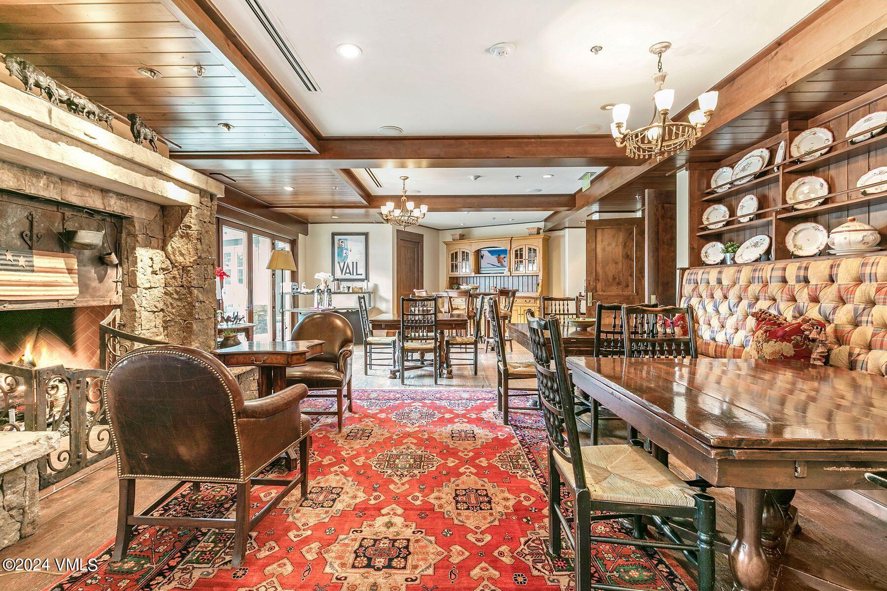1 Willow Bridge Road, Unit 22D Vail, CO 81657 - Photo 36 of 39 a living room with lots of furniture and a chandelier