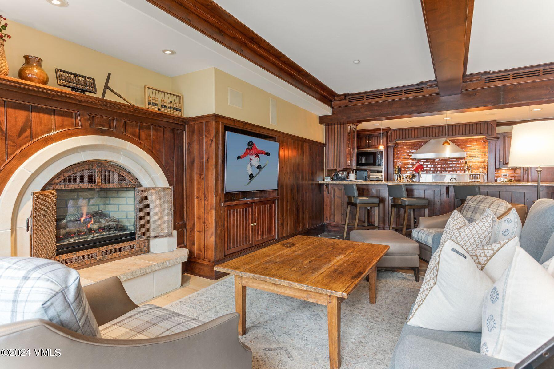 1 Willow Bridge Road, Unit 22D Vail, CO 81657 - Photo 4 of 39 a living room with furniture a fireplace and a table
