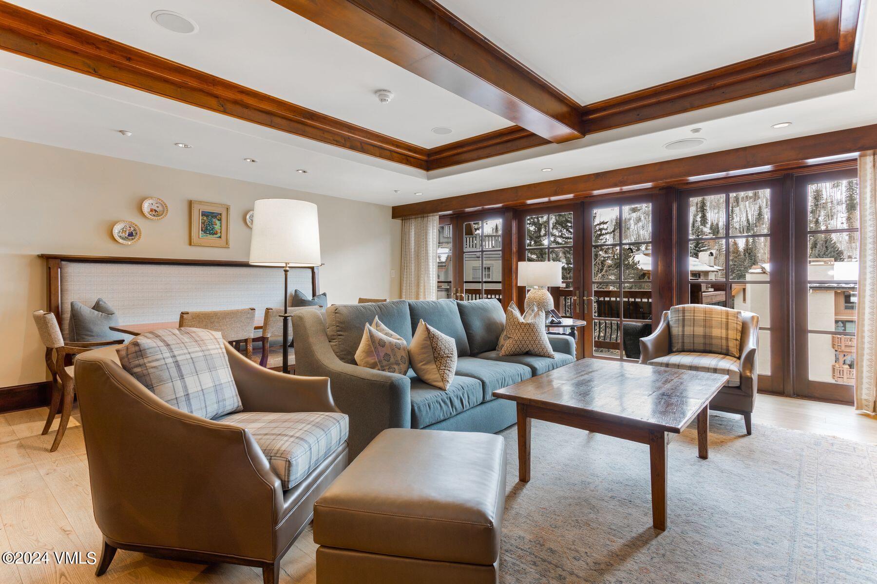 1 Willow Bridge Road, Unit 22D Vail, CO 81657 - Photo 7 of 39 a living room with furniture and a floor to ceiling window