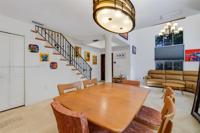 a dining room with furniture and window