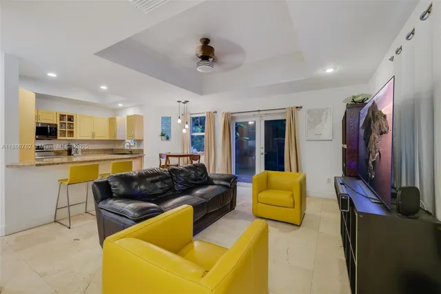 a living room with furniture and kitchen view