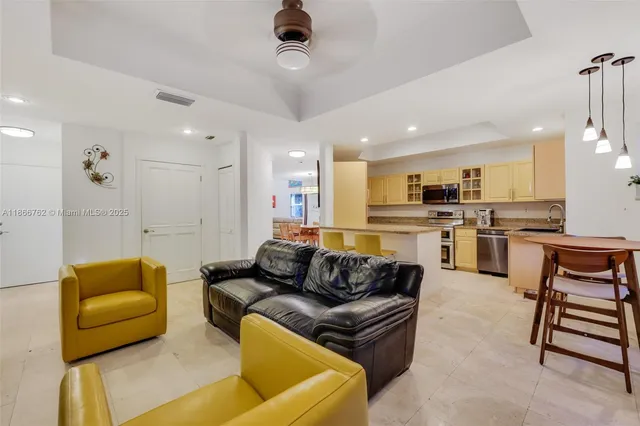 a kitchen with stainless steel appliances a stove a table and chairs in it