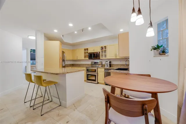 a kitchen with stainless steel appliances granite countertop a stove microwave and refrigerator