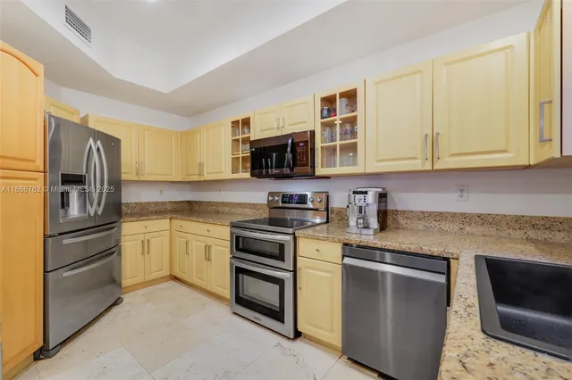 a view of a dining room with furniture and a flat screen tv