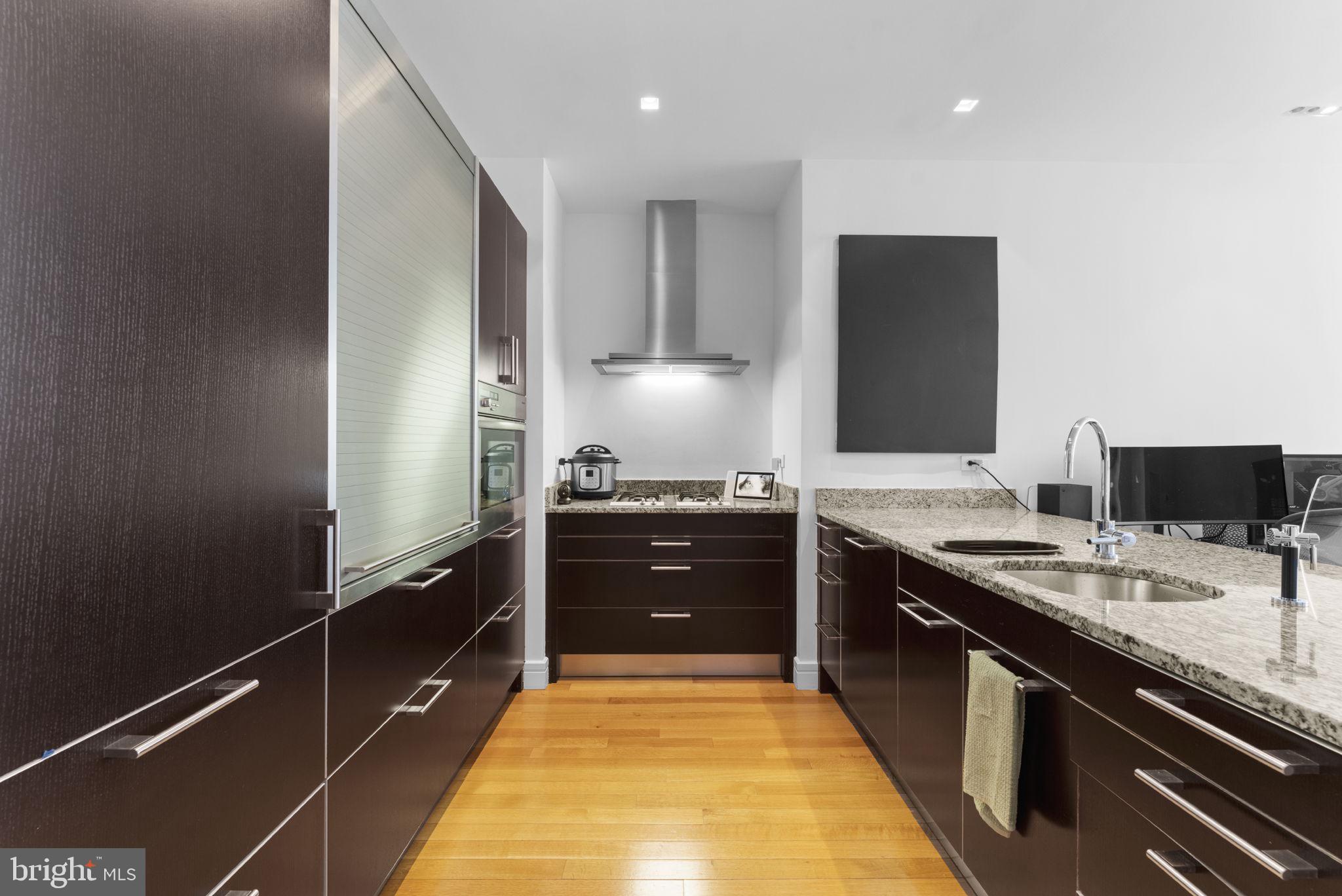 3303 Water Street Northwest, Unit 4B Washington, DC 20007 - Photo 11 of 66 a large kitchen with a stove and a refrigerator