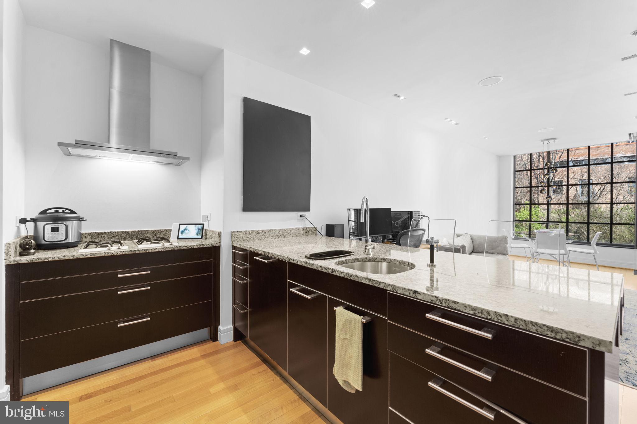3303 Water Street Northwest, Unit 4B Washington, DC 20007 - Photo 13 of 66 a kitchen with a sink and cabinets