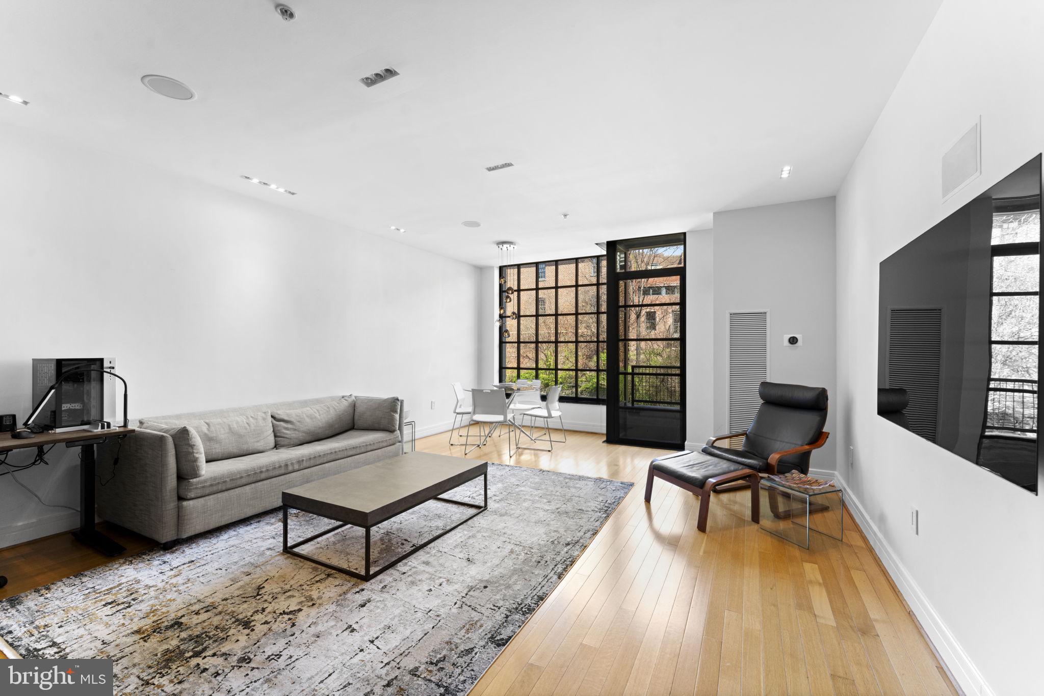3303 Water Street Northwest, Unit 4B Washington, DC 20007 - Photo 14 of 66 a living room with furniture rug and a flat screen tv