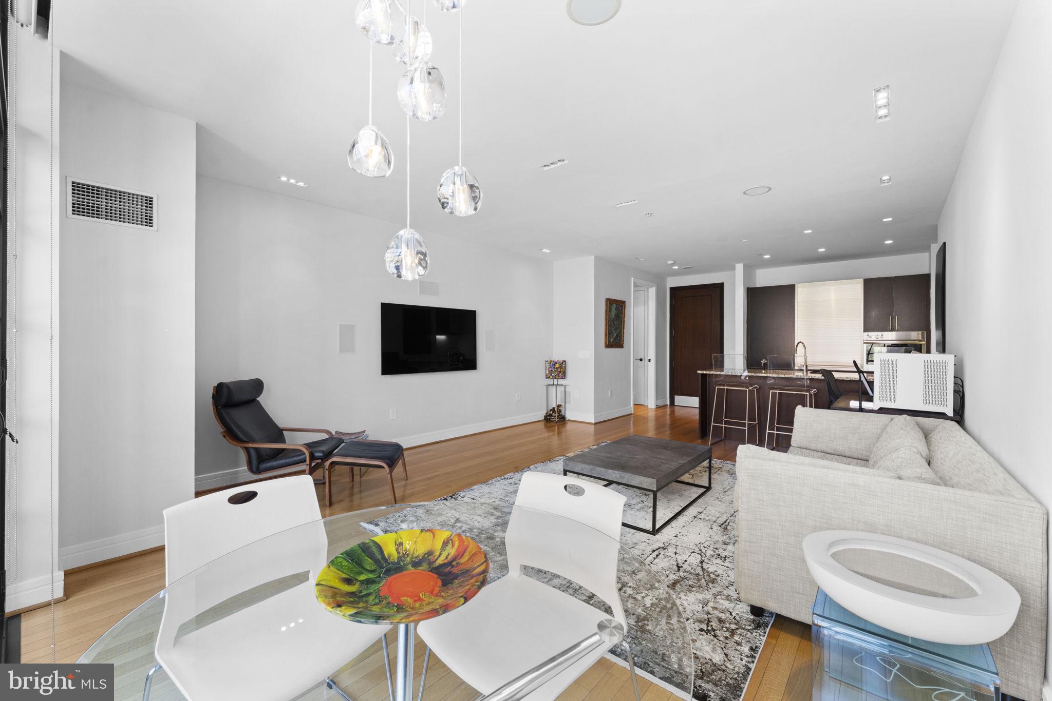 3303 Water Street Northwest, Unit 4B Washington, DC 20007 - Photo 16 of 66 a living room with furniture and a flat screen tv