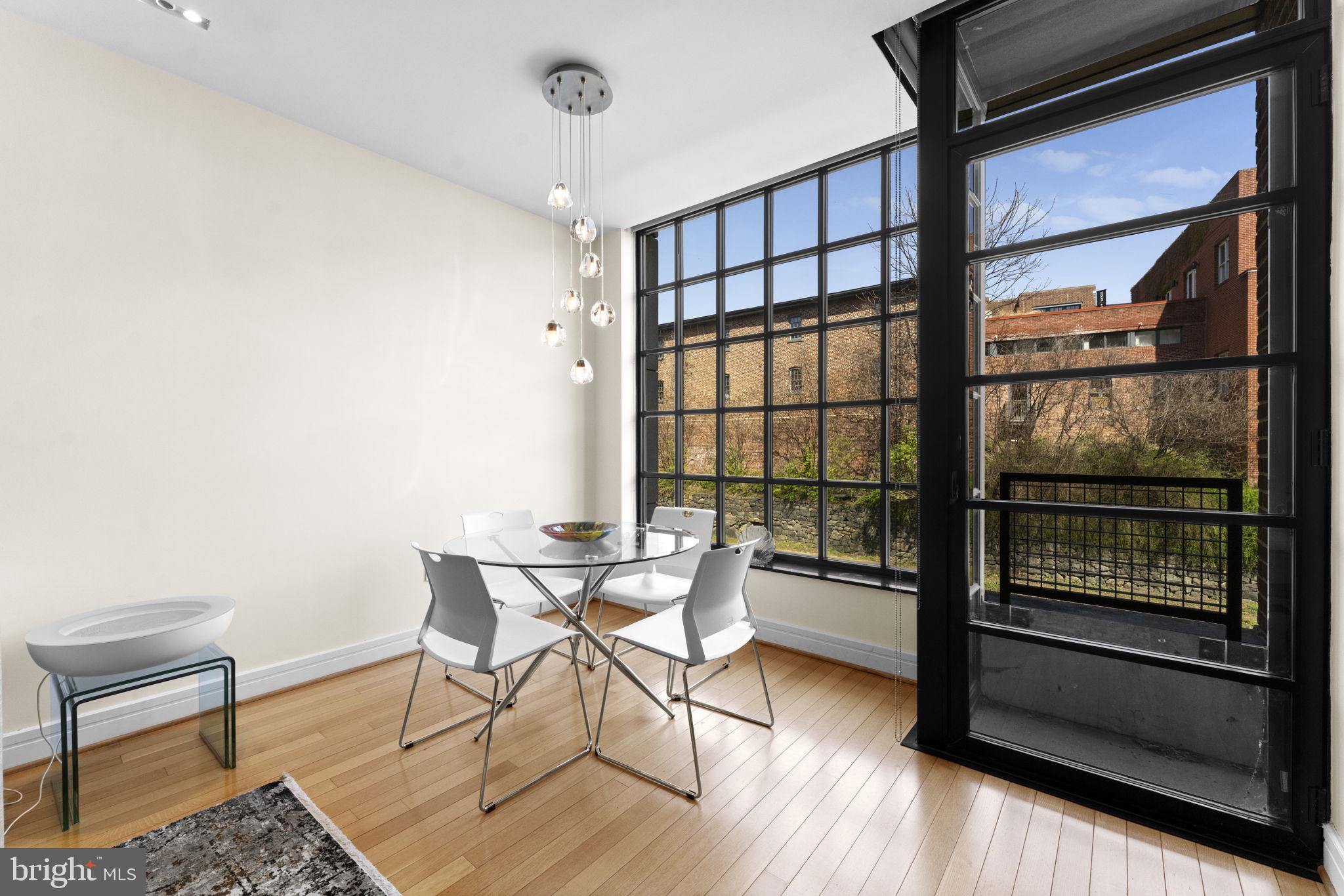 3303 Water Street Northwest, Unit 4B Washington, DC 20007 - Photo 17 of 66 a dining room with wooden floor and a window