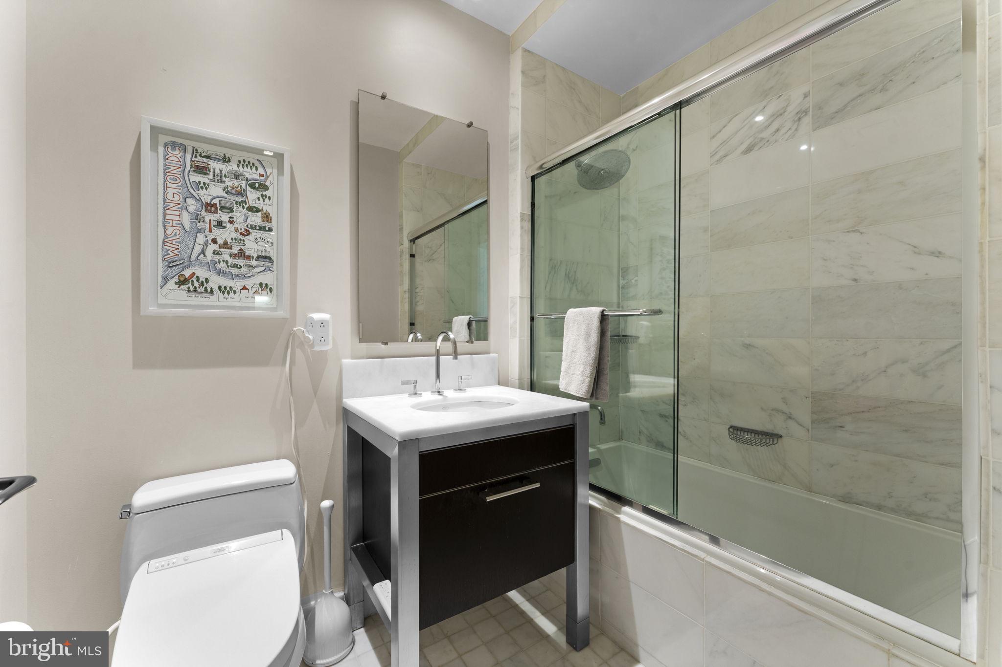 3303 Water Street Northwest, Unit 4B Washington, DC 20007 - Photo 22 of 66 a bathroom with a sink a toilet and shower