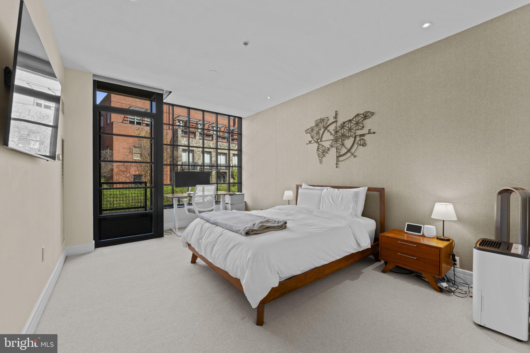 3303 Water Street Northwest, Unit 4B Washington, DC 20007 - Photo 23 of 66 a bed sitting in a bedroom next to a window