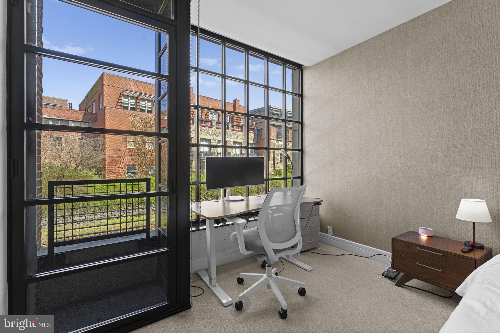 3303 Water Street Northwest, Unit 4B Washington, DC 20007 - Photo 26 of 66 a view of a workspace with furniture and a window