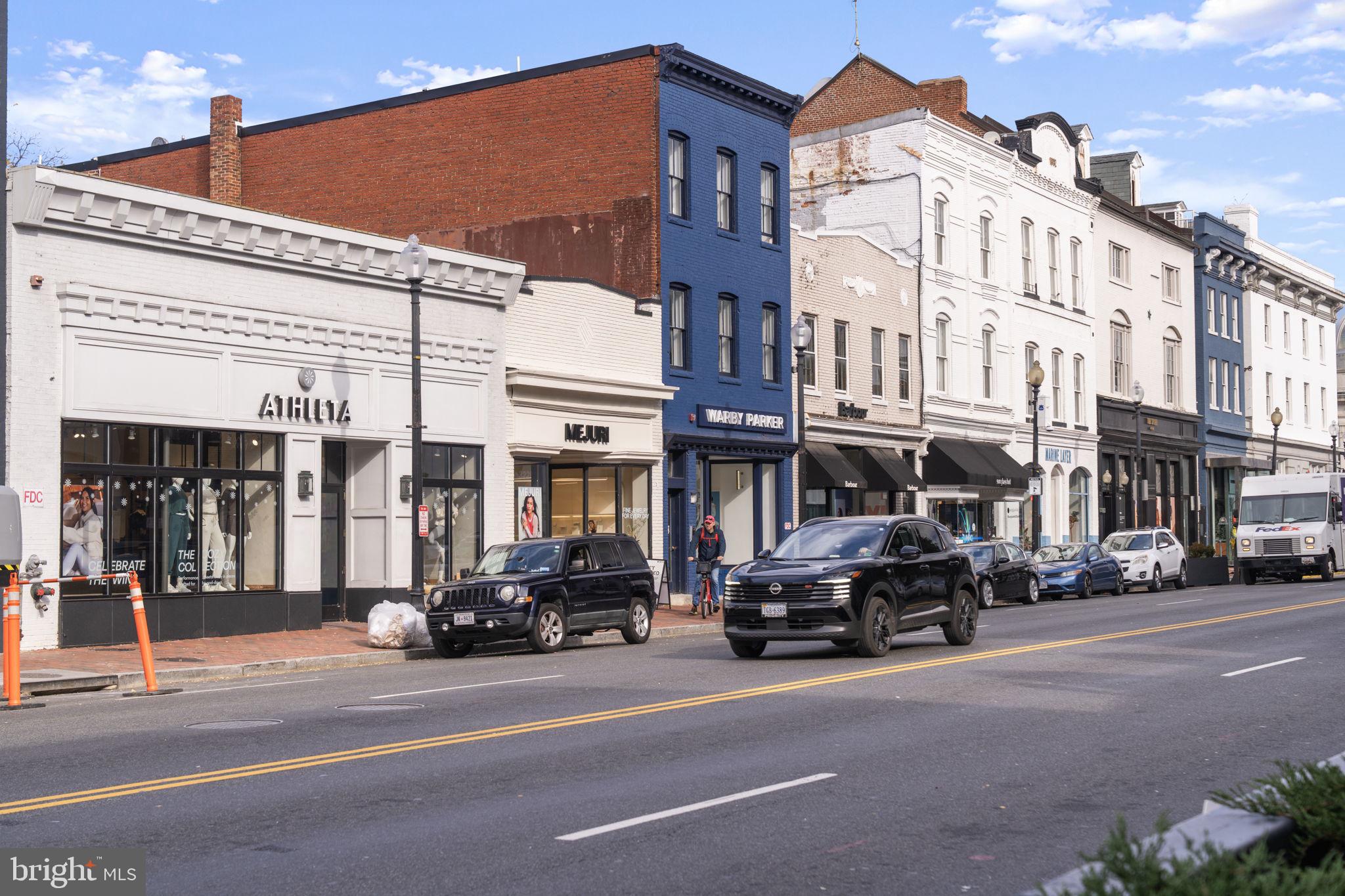3303 Water Street Northwest, Unit 4B Washington, DC 20007 - Photo 66 of 66 a city street lined with parked cars front of buildings