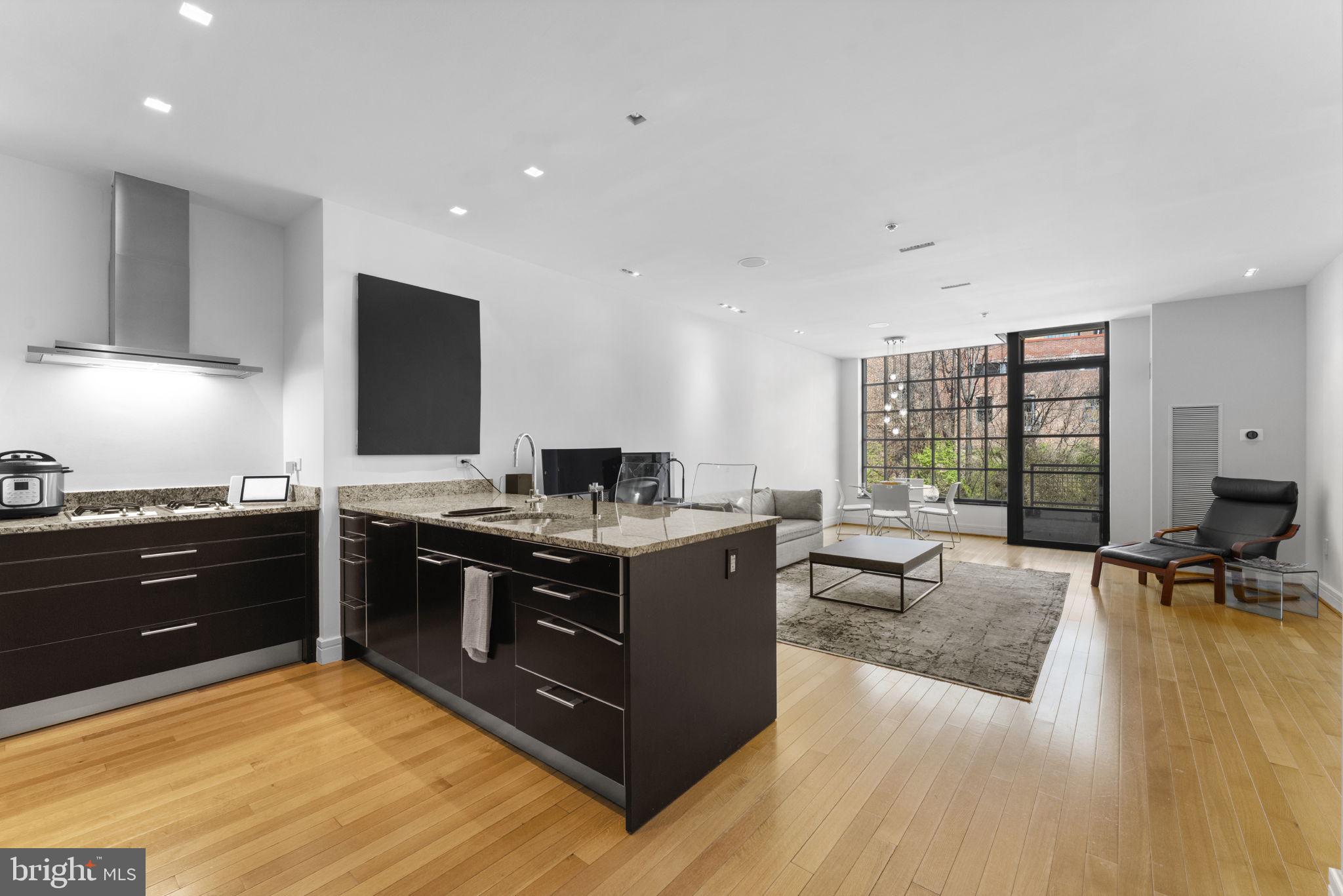 3303 Water Street Northwest, Unit 4B Washington, DC 20007 - Photo 7 of 66 a kitchen with stainless steel appliances granite countertop a stove and a refrigerator
