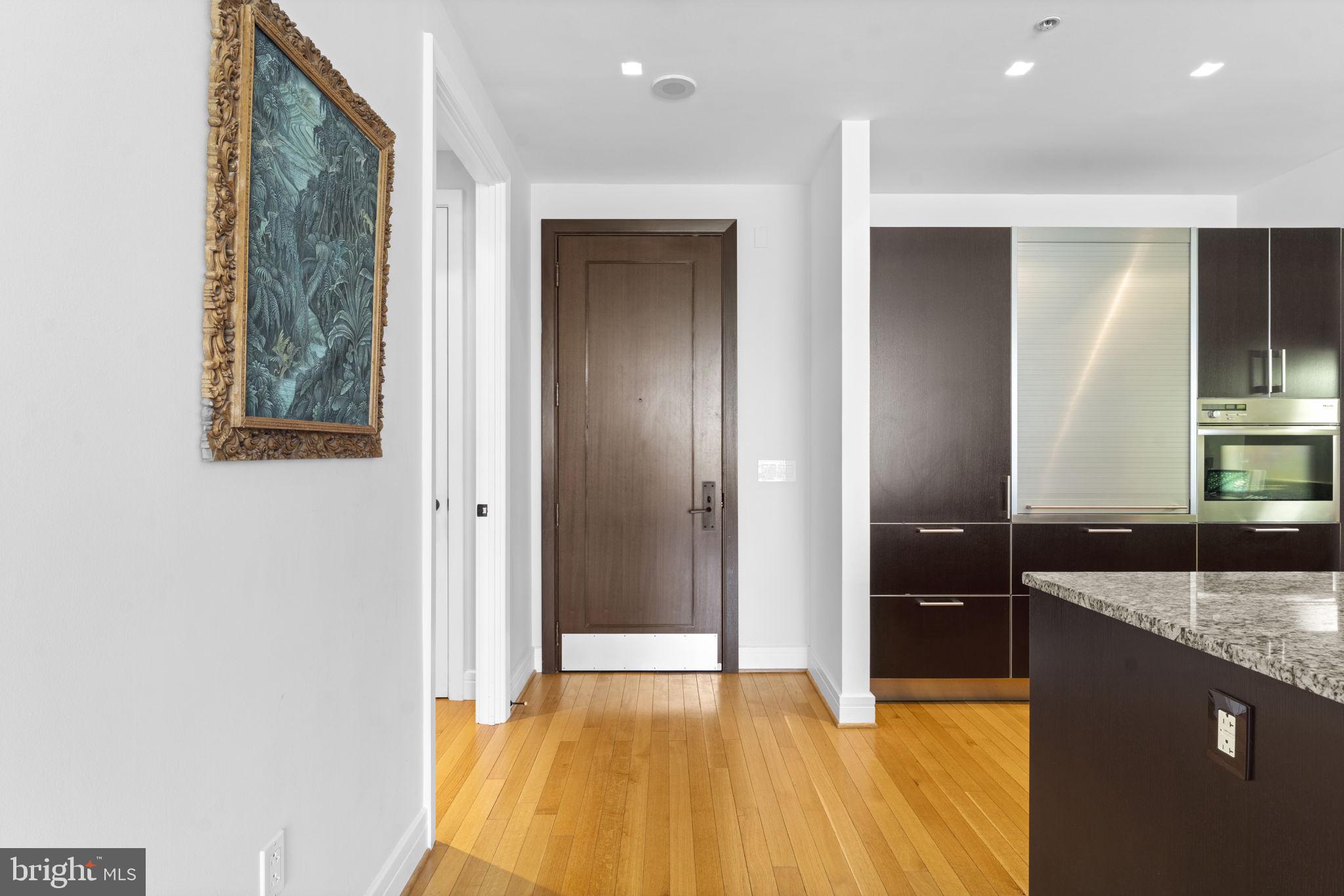 3303 Water Street Northwest, Unit 4B Washington, DC 20007 - Photo 9 of 66 a bathroom with a granite countertop sink and a mirror