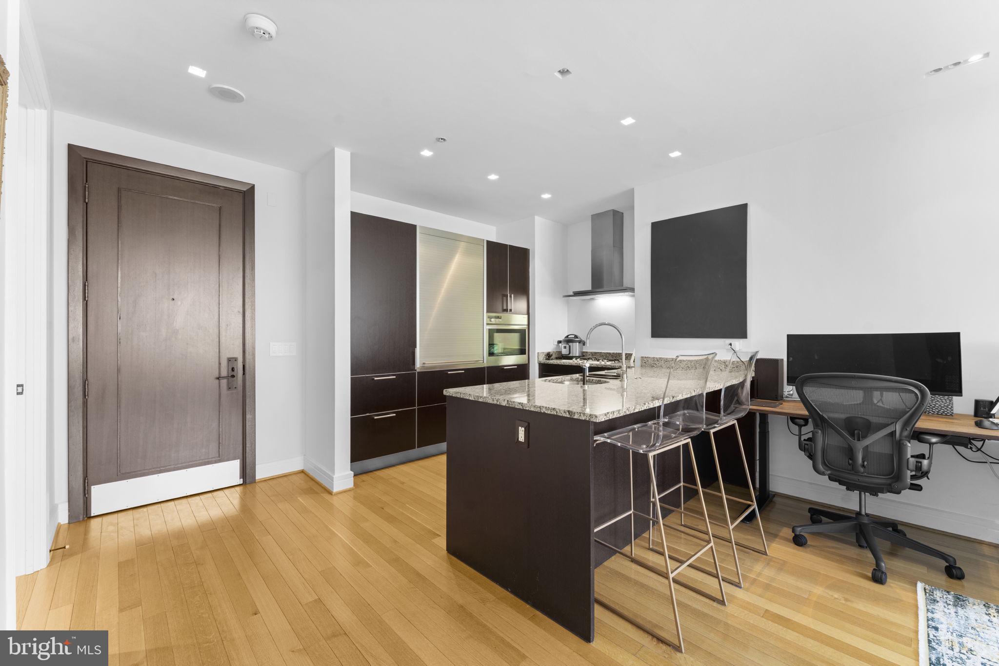 3303 Water Street Northwest, Unit 4B Washington, DC 20007 - Photo 10 of 66 a kitchen with stainless steel appliances granite countertop a stove and a refrigerator