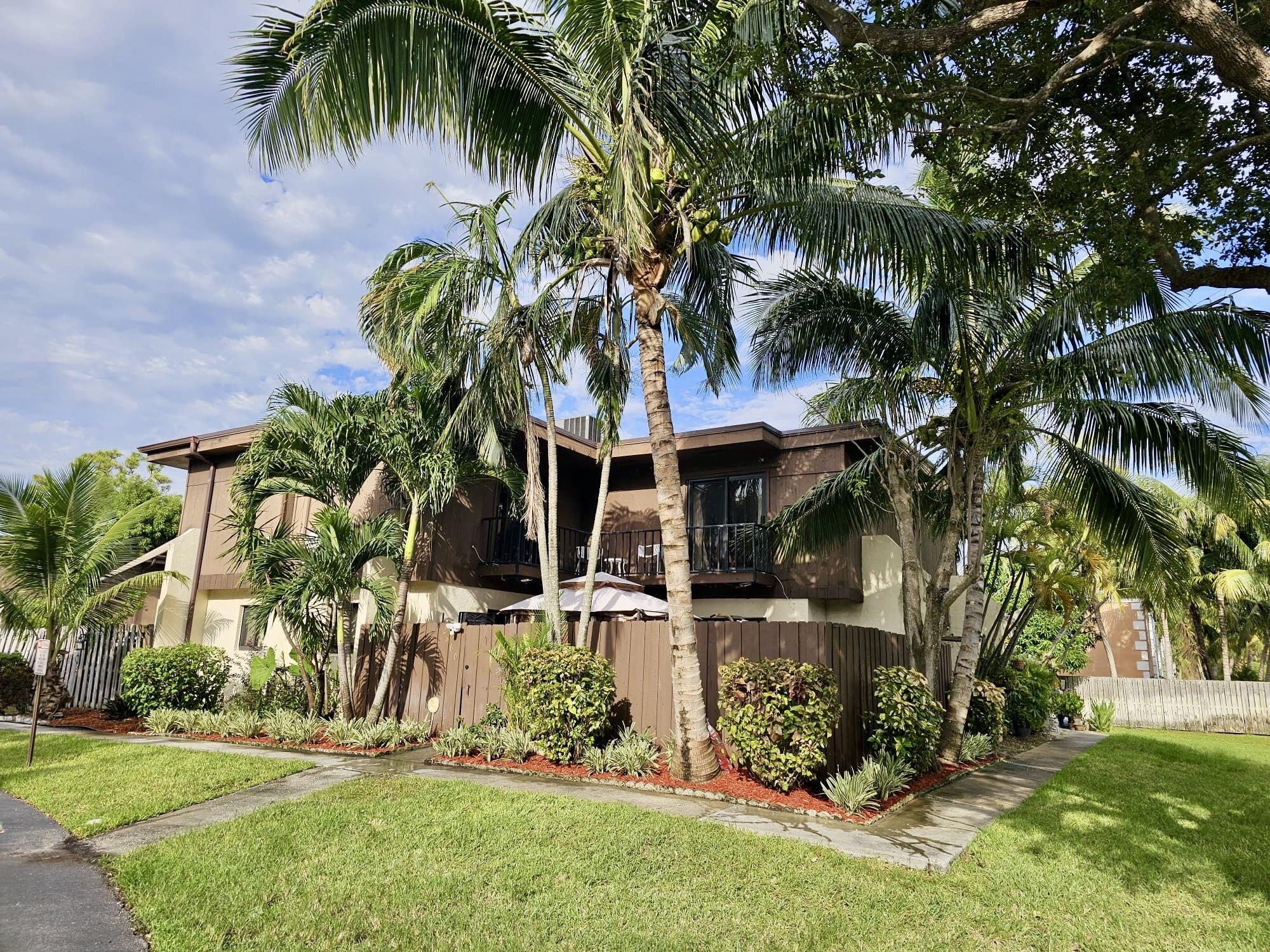 2860 Kirk Road Lake Worth, FL 33461 - Photo 2 of 13 front view of house with a yard and palm trees