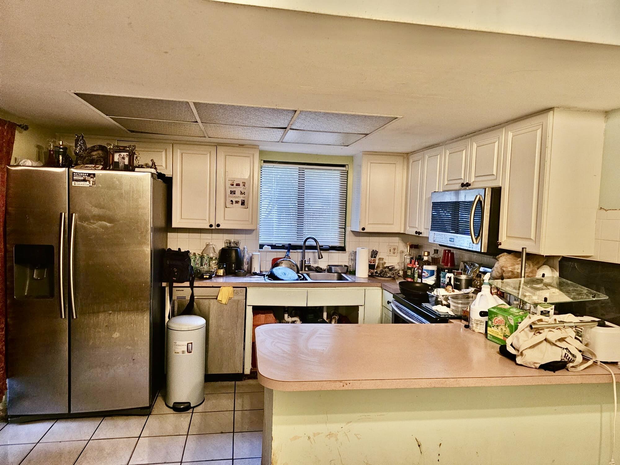 2860 Kirk Road Lake Worth, FL 33461 - Photo 3 of 13 a kitchen with refrigerator and stove