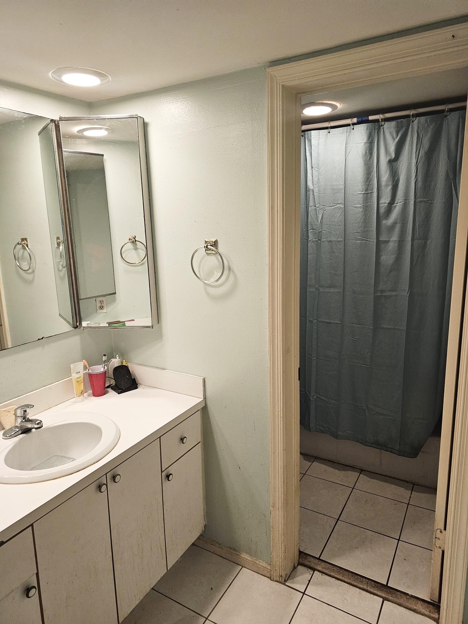 2860 Kirk Road Lake Worth, FL 33461 - Photo 9 of 13 a bathroom with a double vanity sink mirror and shower