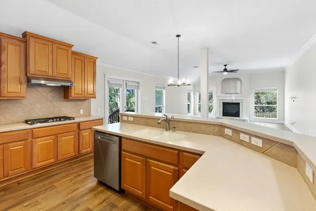 a large kitchen with stainless steel appliances granite countertop a stove a sink and a granite counter tops