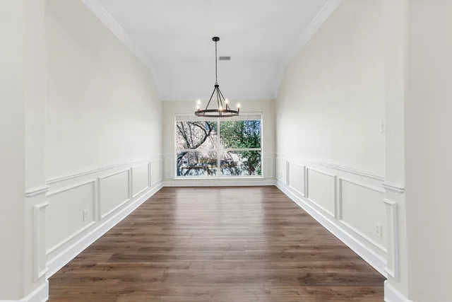 a view of a room with wooden floor and ceiling fan