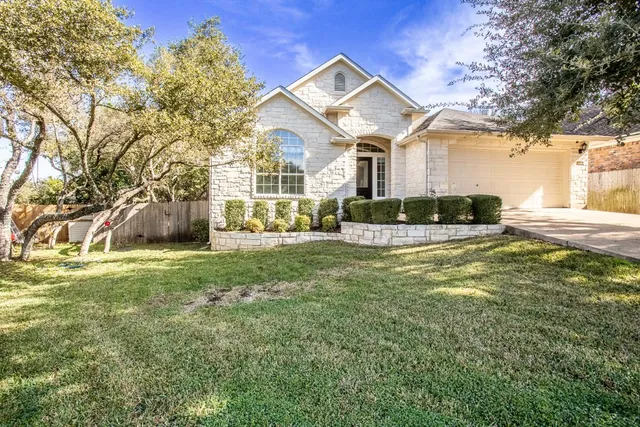 a front view of a house with a yard