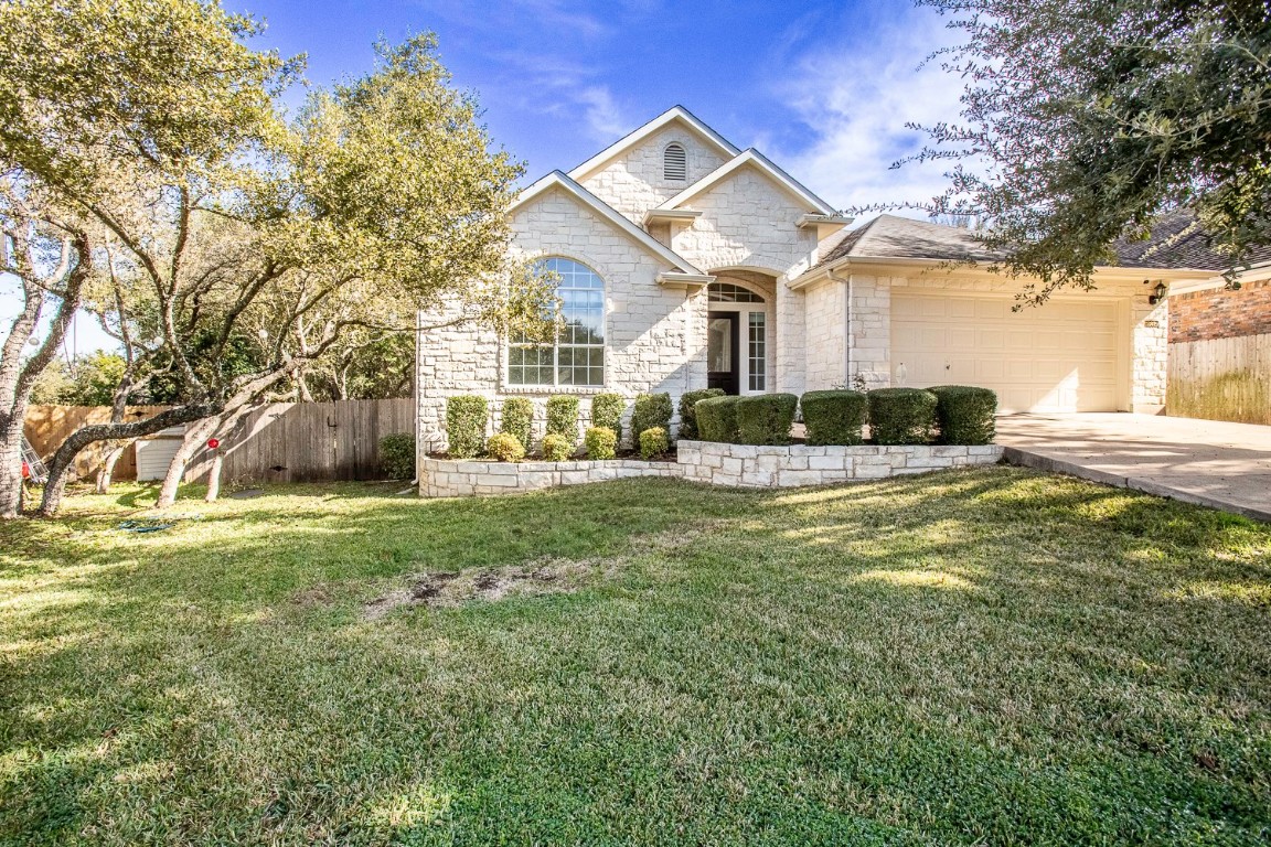 10805 Ariock Lane Austin, TX 78739 - Photo 2 of 40 View of front of property with stone siding, driveway, and a garage