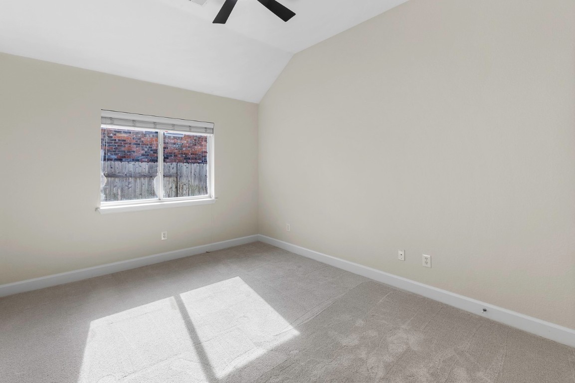 10805 Ariock Lane Austin, TX 78739 - Photo 24 of 40 Spare room with light carpet, lofted ceiling, and a ceiling fan