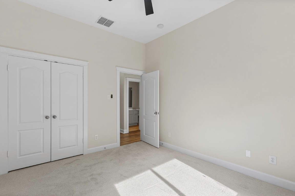 10805 Ariock Lane Austin, TX 78739 - Photo 25 of 40 Unfurnished bedroom with carpet, a closet, and a ceiling fan