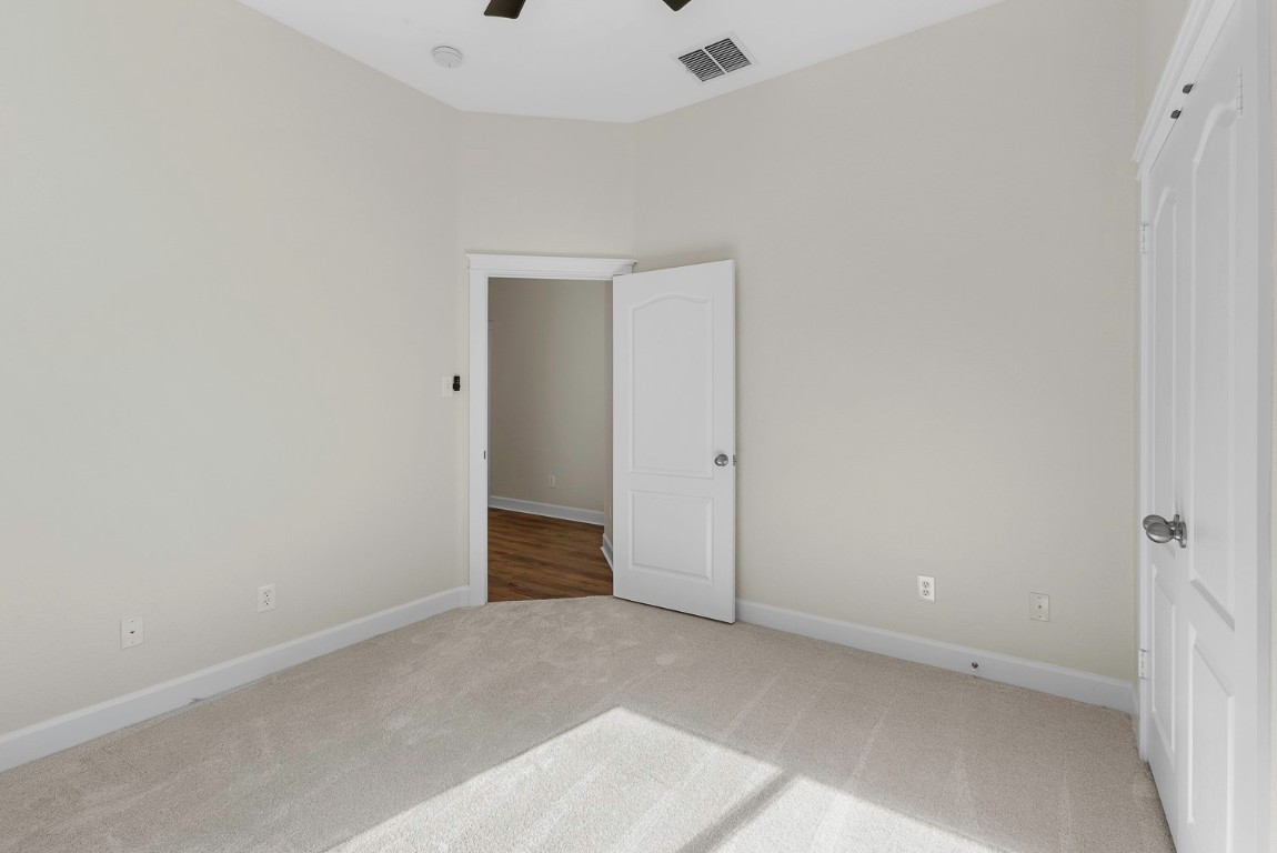 10805 Ariock Lane Austin, TX 78739 - Photo 29 of 40 Unfurnished bedroom featuring ceiling fan and carpet floors