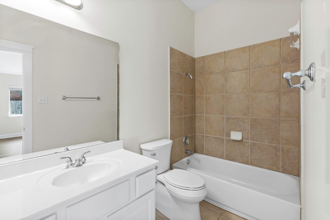 10805 Ariock Lane Austin, TX 78739 - Photo 30 of 40 Bathroom featuring bathing tub / shower combination, vanity, and light tile patterned floors