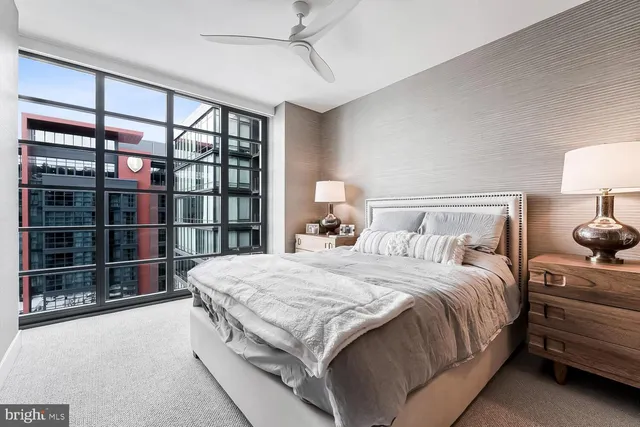 a large bed sitting in a bedroom next to a lamp