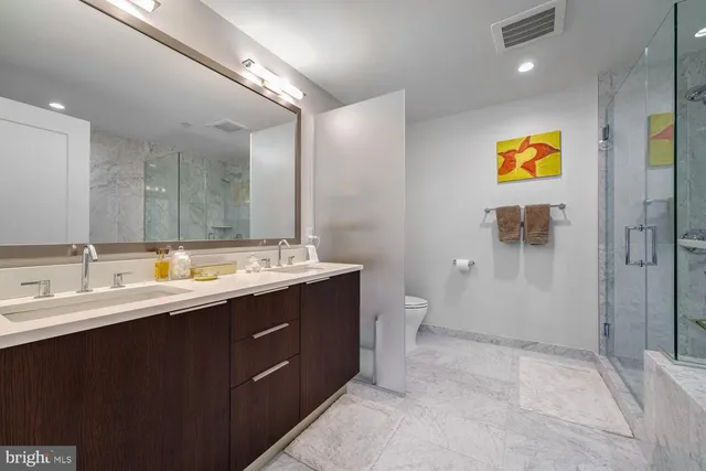 a bathroom with a sink a toilet and mirror