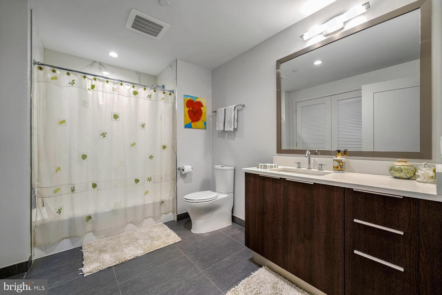 45 Sutton Square Southwest, Unit 1006 Washington, DC 20024 - Photo 22 of 51 a bathroom with a sink and a mirror