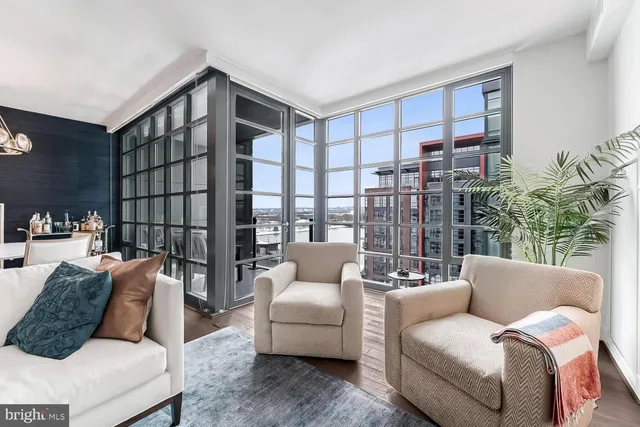 a living room with furniture and a floor to ceiling window