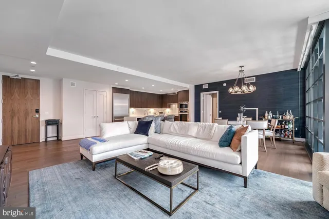 a living room with furniture a rug and a table