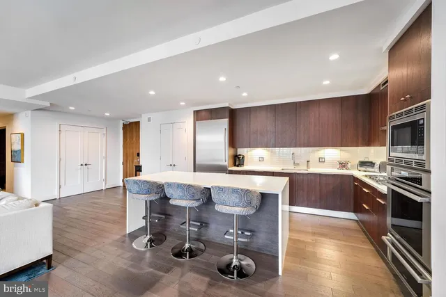 a kitchen with a sink cabinets and wooden floor