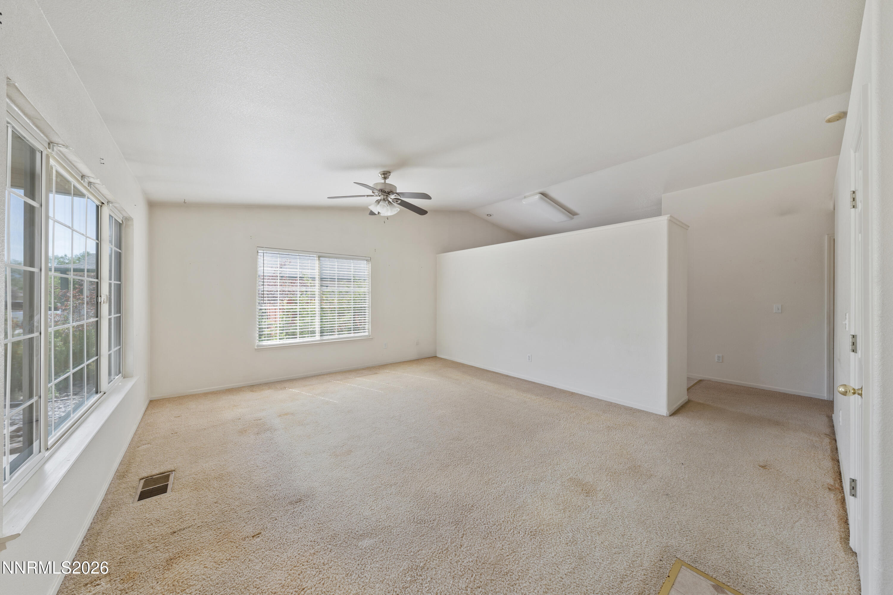 17617 Grand Valley Court Reno, NV 89508 - Photo 2 of 15 an empty room with windows and chandelier fan