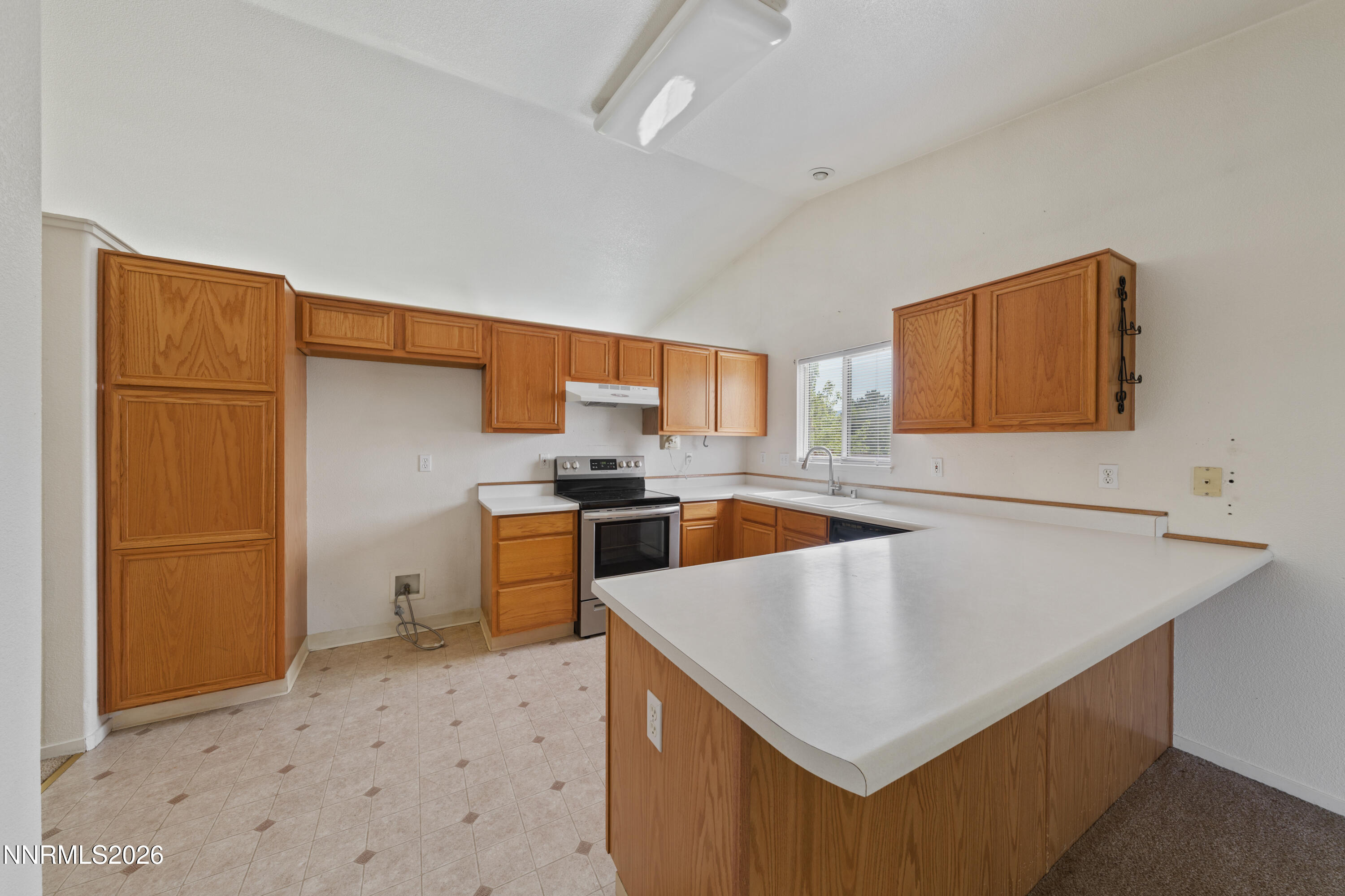 17617 Grand Valley Court Reno, NV 89508 - Photo 4 of 15 a kitchen with a stove a sink and a refrigerator