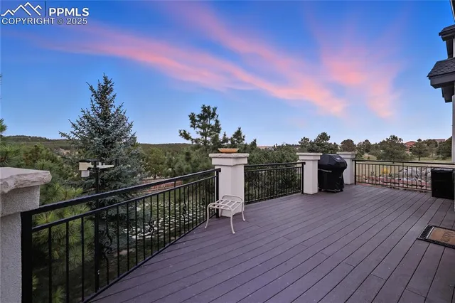 a view of a roof deck with chair and wooden floor