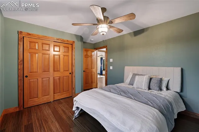 a bedroom with a large bed and wooden floor