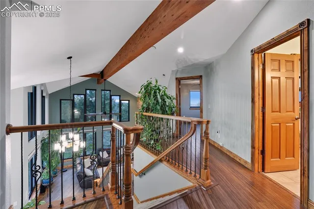 a view of staircase with railing and a chandelier
