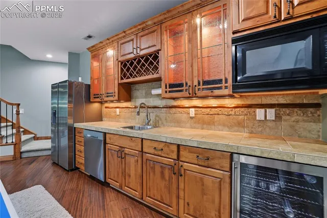 a kitchen with stainless steel appliances granite countertop a sink and a microwave