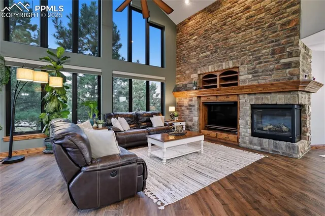 a living room with furniture large window and a fireplace