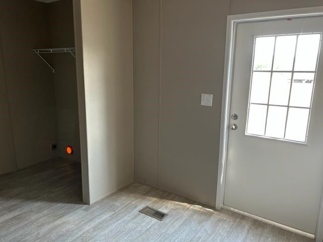 2958 Basstown Road Clinton, NC 28328 - Photo 4 of 7 an empty room with wooden floor and windows