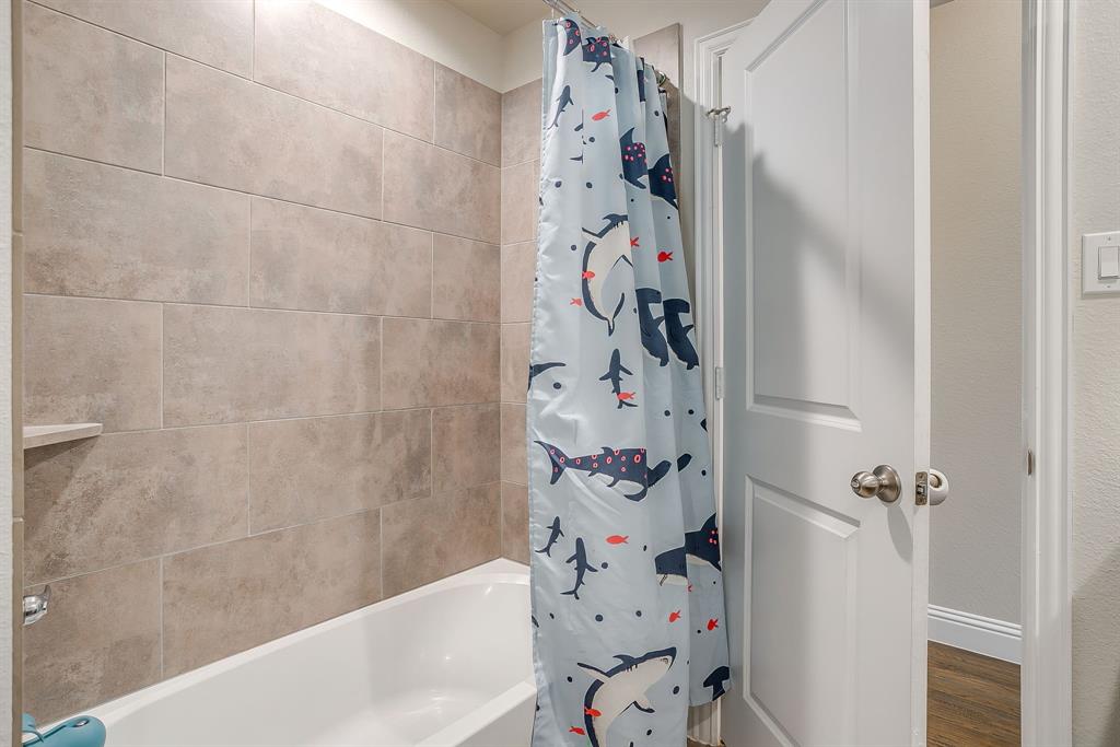 15141 Fleet Hill Road Aledo, TX 76008 - Photo 21 of 37 Tiled shower tub combo in bathroom 2.