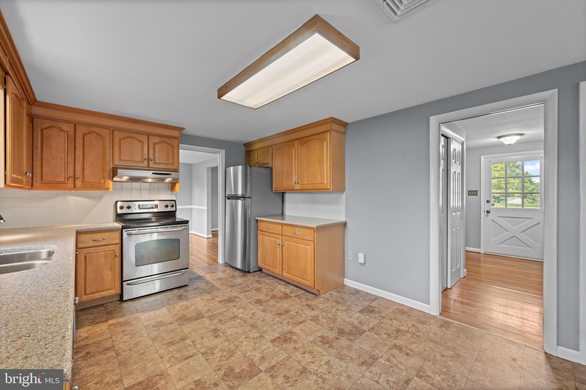 258 Monacy Road Coatesville, PA 19320 - Photo 21 of 54 a kitchen with granite countertop a refrigerator stove top oven and sink