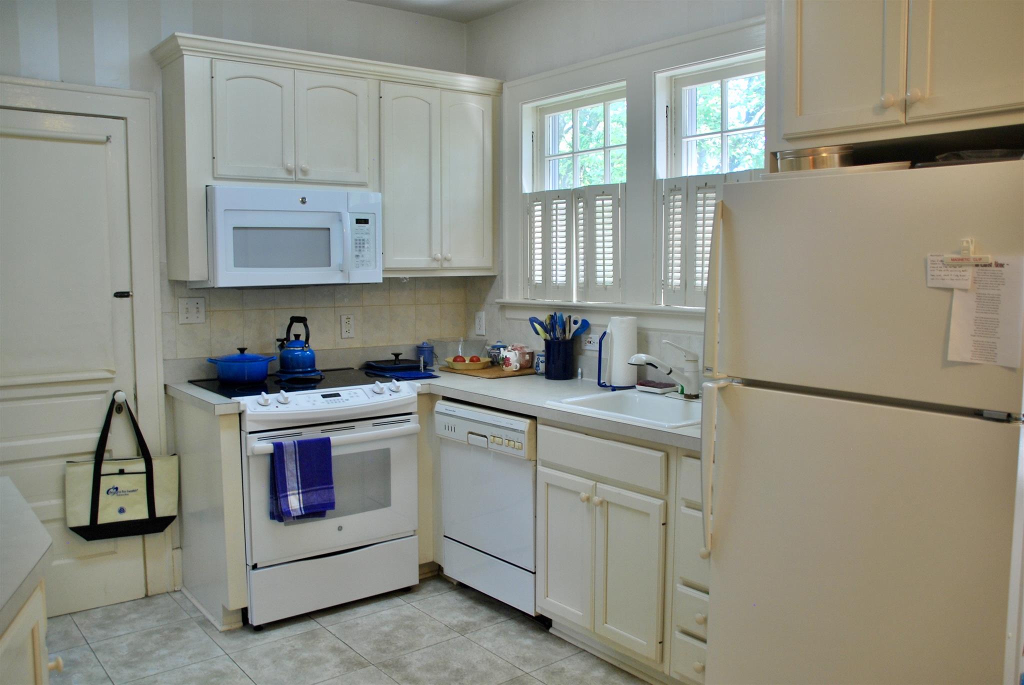906 Estes Road Nashville, TN 37215 - Photo 6 of 15 a kitchen with white cabinets and white appliances