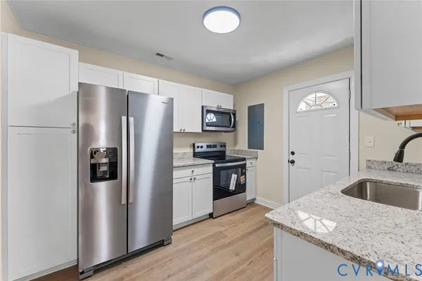 a kitchen with a refrigerator sink and stainless steel appliances