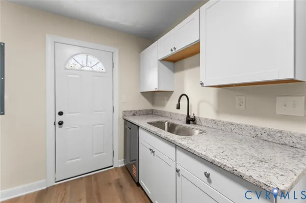 a kitchen with granite countertop cabinets stainless steel appliances and a counter space